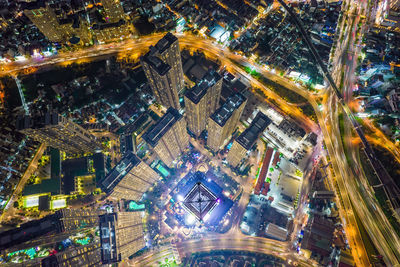 High angle view of city lit up at night