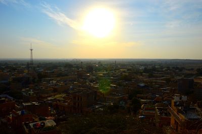 Aerial view of town against sky during sunset