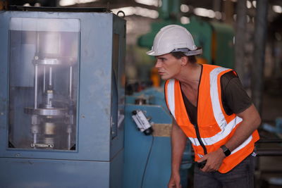 Young man working in factory