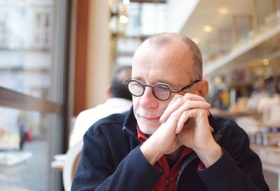 Man looking away while sitting at restaurant