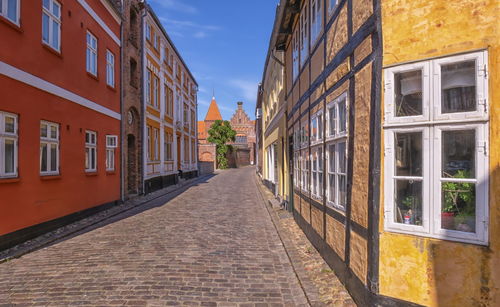 Street amidst buildings in city against sky