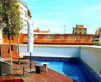 Swimming pool by sea against sky in city