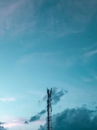 Low angle view of communications tower against blue sky