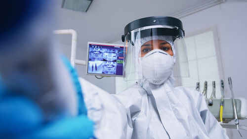 Midsection of woman wearing mask