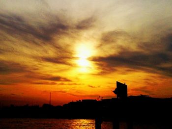 Silhouette of tree against dramatic sky