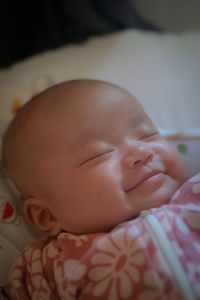 Close-up of cute baby boy sleeping on bed at home