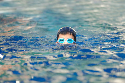 Portrait of boy swimming in pool