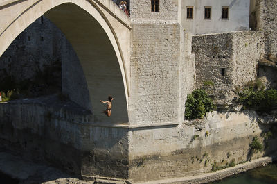 Arch bridge over buildings in city