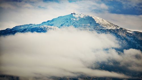 Low angle view of snowcapped mountains against sky