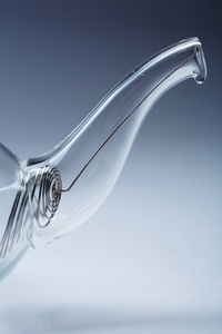Close-up of glass over water against white background