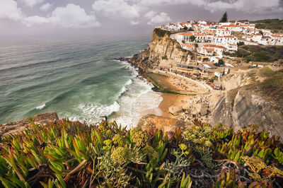 Aerial view of town on mountain by sea