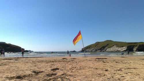 Scenic view of beach against clear blue sky