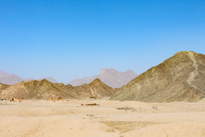 Idyllic shot of mountains in desert against clear blue sky