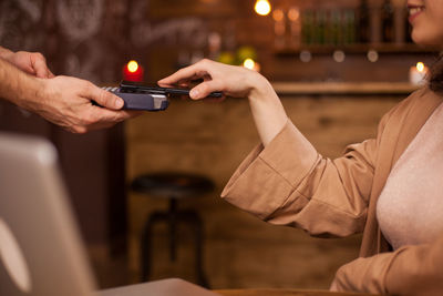 Midsection of woman using mobile phone