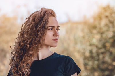 Portrait of young woman looking away