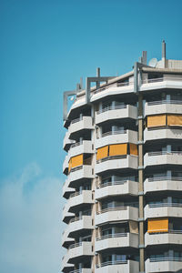 Low angle view of modern building against clear blue sky