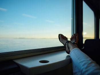 Cropped image of woman sitting on bench