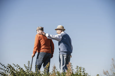 Two old friends taking a stroll through the fields, talking about old times