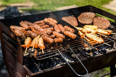 High angle view of meat on barbecue grill