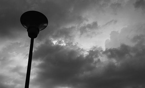 Low angle view of street light against cloudy sky