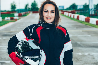 Portrait of smiling woman standing outdoors