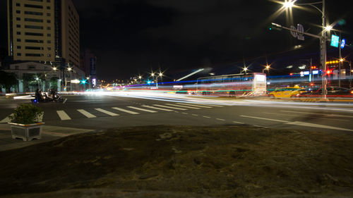 Light trails on road in city at night