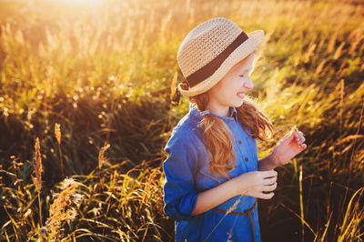 Smiling girl looking away against plants