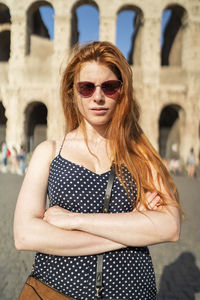 Confident ginger woman outside famous monument