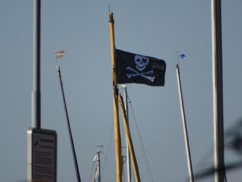 Low angle view of sailboat against clear blue sky