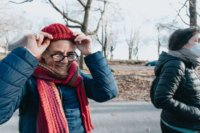 Smiling woman wearing warm clothing during winter