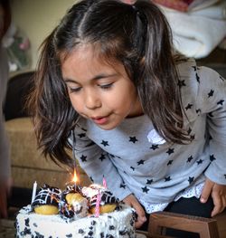 Close-up of girl blowing birthday candles