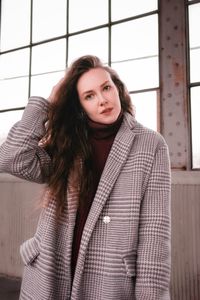 Portrait of beautiful young woman standing in winter