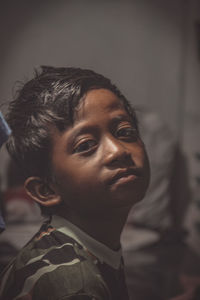 Close-up portrait of boy looking away