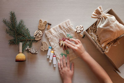 Cropped hand of woman holding christmas tree