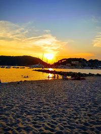 Scenic view of beach against sky during sunset