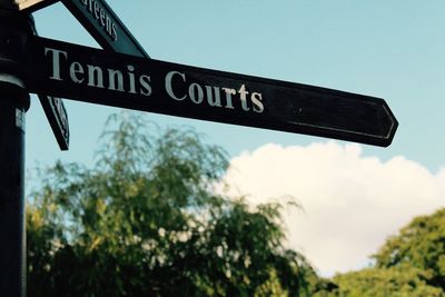 Low angle view of signboard against sky