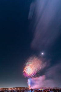 Low angle view of firework display at night