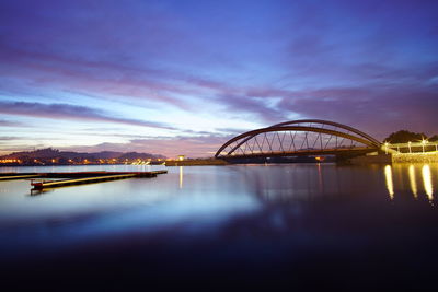 Reflection of illuminated bridge in water