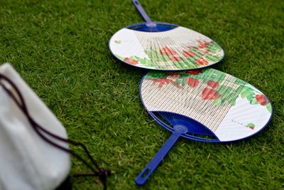 High angle view of hand fan on grass