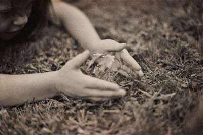 Close-up of hand on grassy field