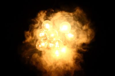 Close-up of illuminated light painting against black background