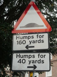 Close-up of road sign against trees