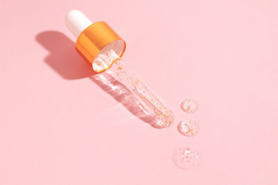 Close-up of pills against pink background