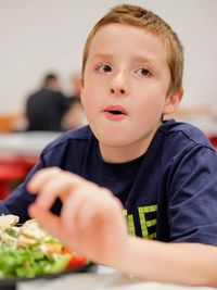 Portrait of boy sitting on table