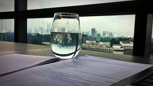 Close-up of water in city against sky