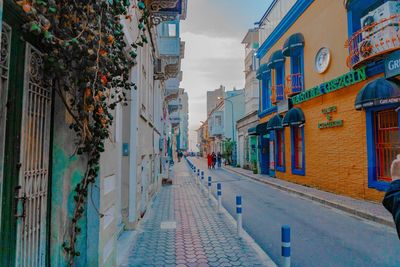 Footpath amidst buildings in city