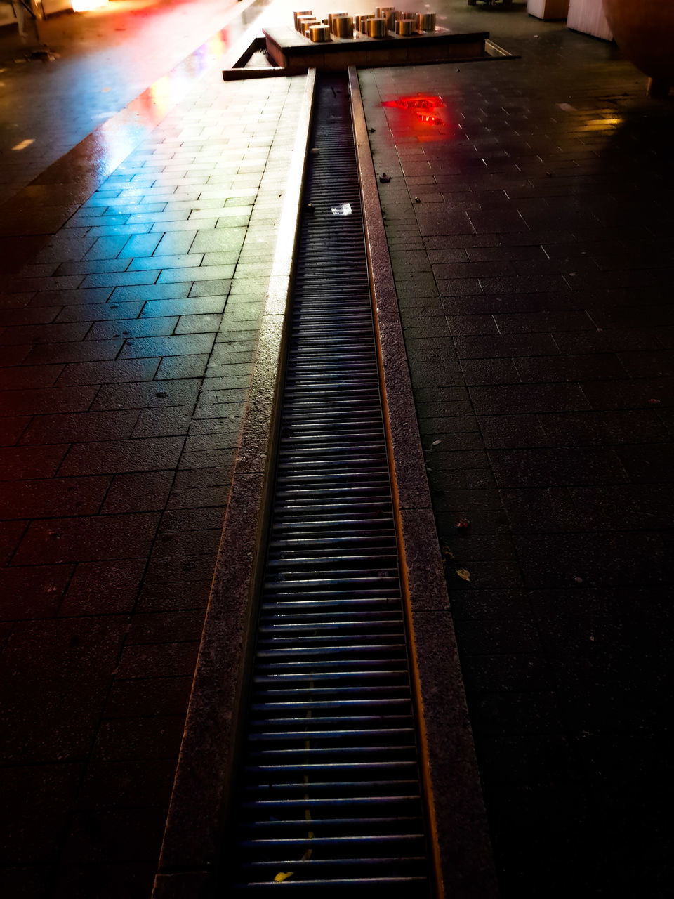 HIGH ANGLE VIEW OF WET FOOTPATH