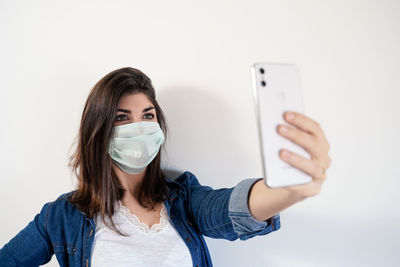 Portrait of young woman using mobile phone