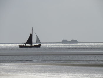 Sailboat on sea against clear sky