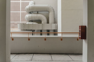 Metallic pipes on wall seen from balcony